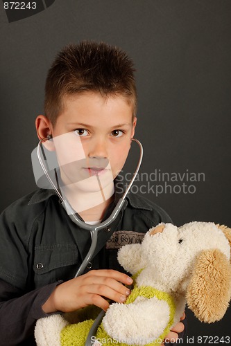 Image of Little boy with stuffed dog
