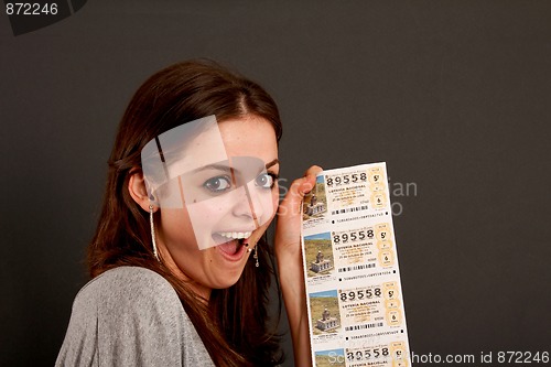 Image of Pretty young girl hold a spanish lottery ticket.