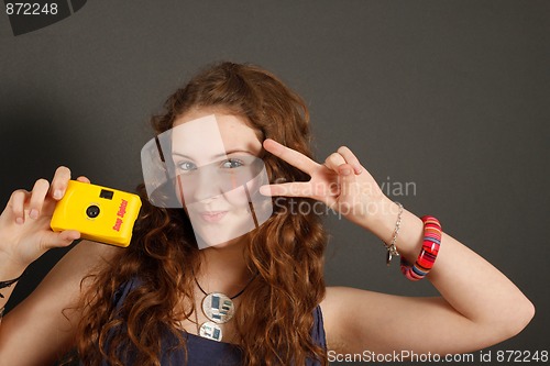 Image of A young girl with a disposable camera