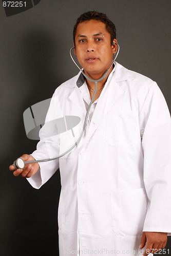 Image of Doctor with percing standing isolated over a black background
