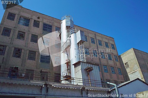 Image of Old industrial building exterior with addition of a new tower