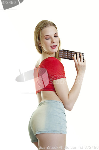 Image of young woman eating chocolate 