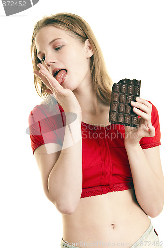 Image of young woman enjoying large  chocolate  bar