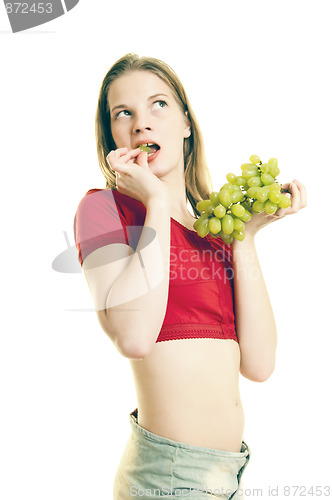 Image of young woman eating grapes