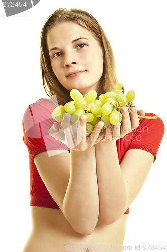 Image of young woman holding  grapes