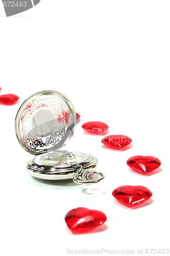 Image of Clock with red hearts on white background