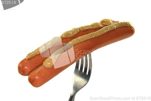 Image of Wieners with mustard on a fork