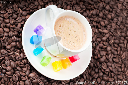 Image of Multicolored slabs of shugar and cup of coffee 