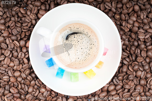 Image of Multicolored slabs of shugar and cup of coffee 