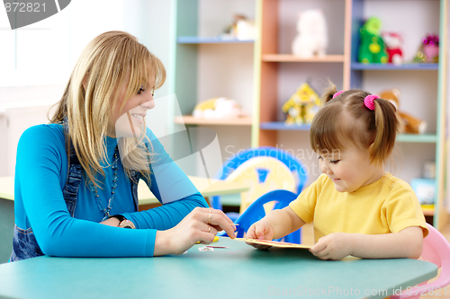 Image of Teacher with child in preschool