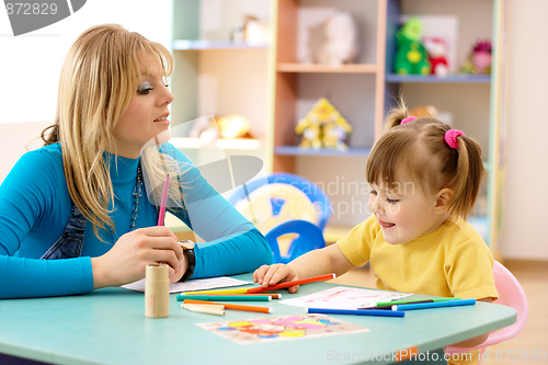 Image of Teacher with child in preschool