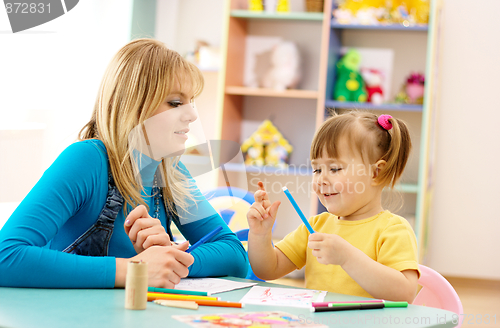 Image of Teacher with child in preschool