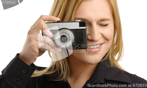 Image of young woman taking a shot with photo camera