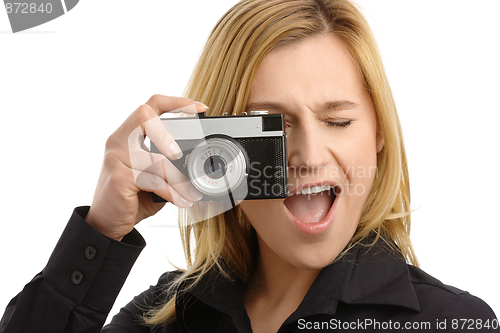 Image of young woman taking a shot with photo camera