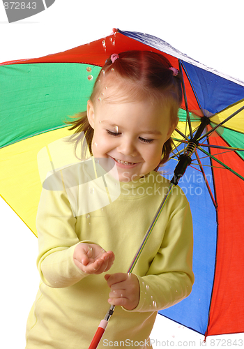 Image of Cute child catching raindrops under umbrella