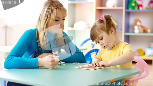 Image of Teacher with child in preschool
