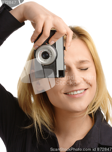 Image of young woman taking a shot with photo camera