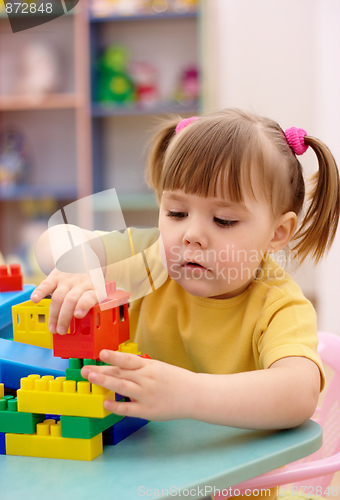 Image of Little girl play with building bricks in preschool