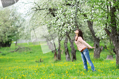 Image of Woman smelling flowers