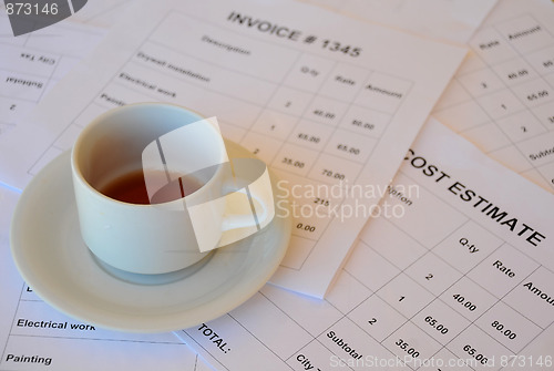 Image of Half Empty Cup of Tea on Financial Documents