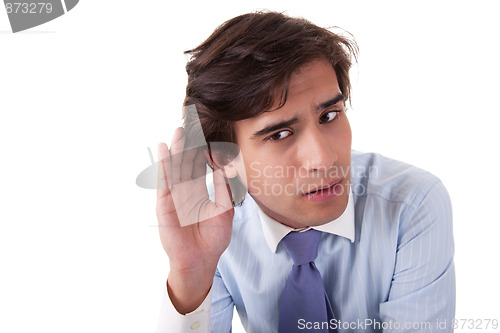 Image of Young businessman, listening, viewing the  gesture of hand behind the ear