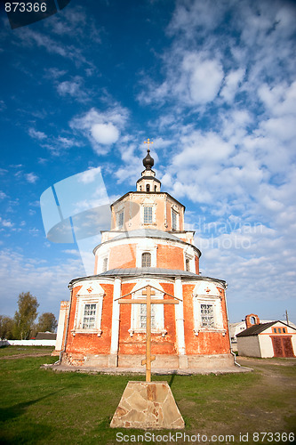 Image of Wooden cross against a church