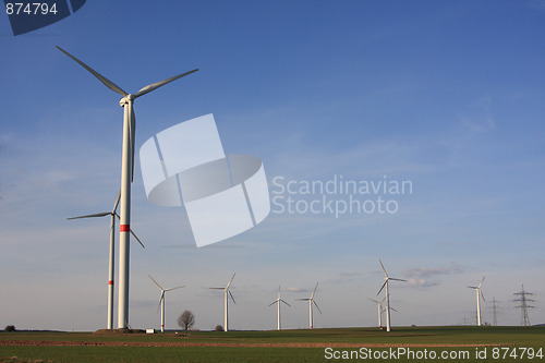 Image of wind turbines under blue sky