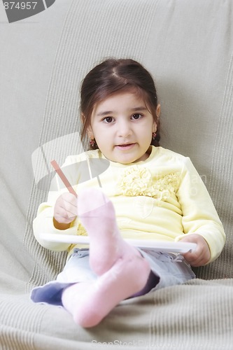 Image of Girl in yellow with pencil