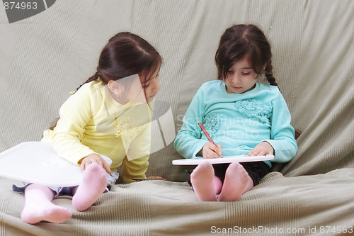 Image of Girl looking at sister work