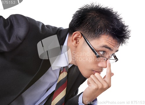 Image of Scrutinizing skeptical businessman