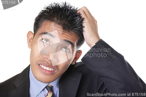 Image of Worried businessman scratching head