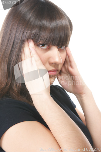 Image of Brunette in black pressing temples