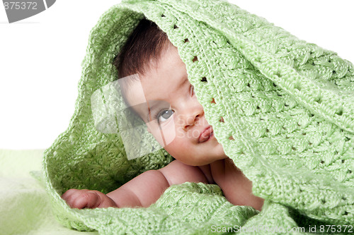 Image of Cute happy baby between green blankets