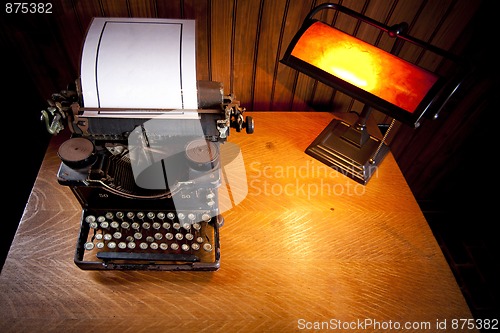 Image of Desk with old typewriter and lamp