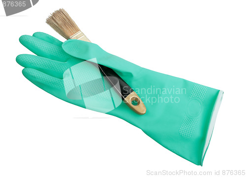 Image of One green rubber glove and brush.