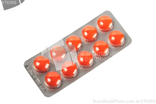 Image of Orange pills in metallic blister.