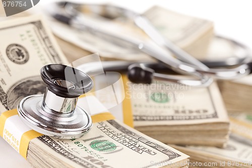 Image of Stethoscope Laying on Stacks of Money