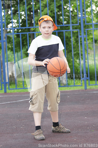 Image of Boy tapping basketball