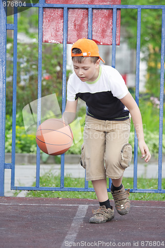 Image of Boy dribbling basketball