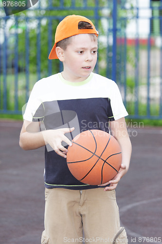 Image of Boy holding basketball