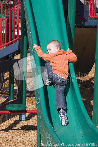 Image of Little Boy Going Up the Slider