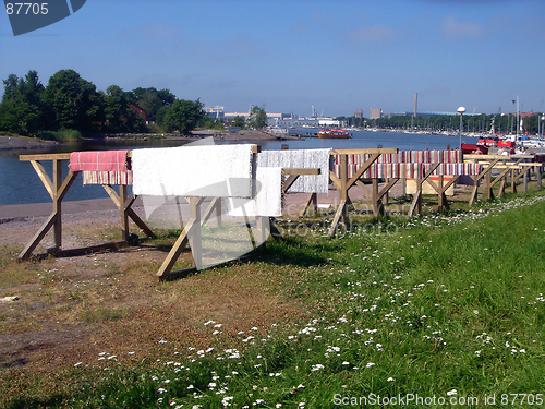 Image of Carpets and doormats are dried on the sun on quay of city Helsinki