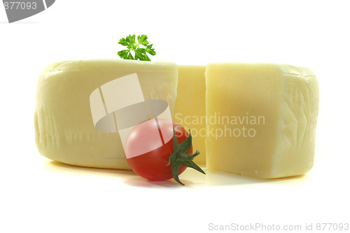 Image of Cheese wheel with a piece of cheese