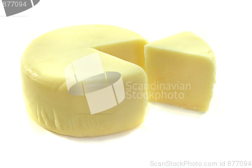 Image of Cheese wheel with a piece of cheese