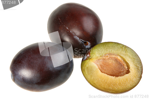 Image of Three dark-purple plums.