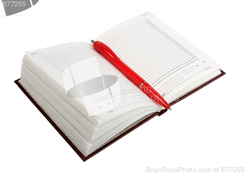 Image of Empty open diary and red ball point pen.