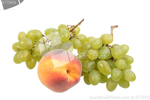 Image of Green grapes bunch and one orange peach.