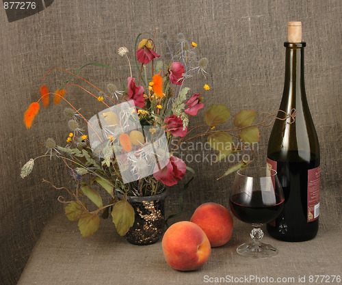 Image of Two orange peach, bouquet and red wine.