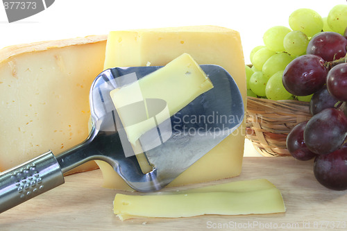 Image of Cheese with a cheese slicer