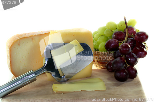 Image of Cheese with a cheese slicer
